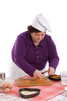 Female chef arranging the carrots on her wooden chopping board
