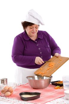 Female chef putting the carrots in the bowl