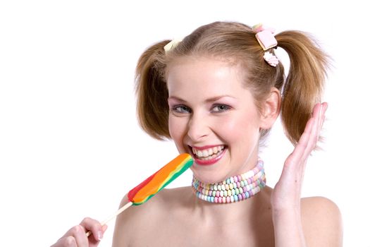 Pretty blond girl with ponytails laughing with a candy cane