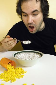 A man feeding himself medication with a spoon. Metaphor for addiction, dependency, etc.
