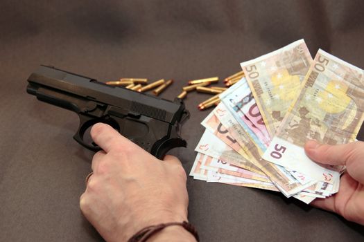 concept of a drug deal or gun hire going down against a dark background