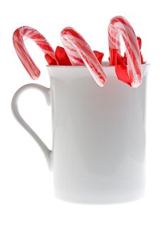 sugar canes in a white cup isolated