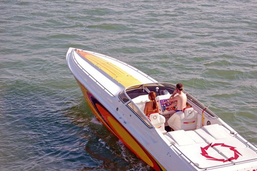 Young couple enjoying a cruise on biscayne bay in a power speed boat