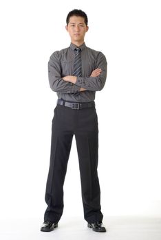 Confident young business man standing and looking, full length portrait on white.