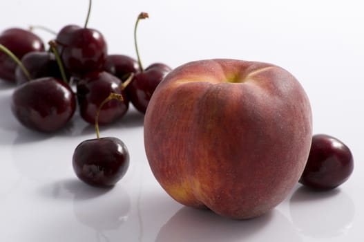 One peach and a cherries group on white background