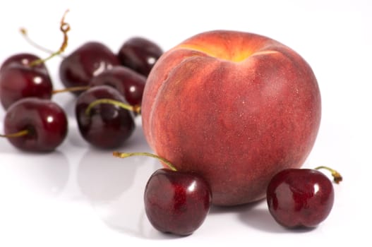 One peach and a cherries group on white background