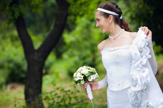 a happy bride near the tree
