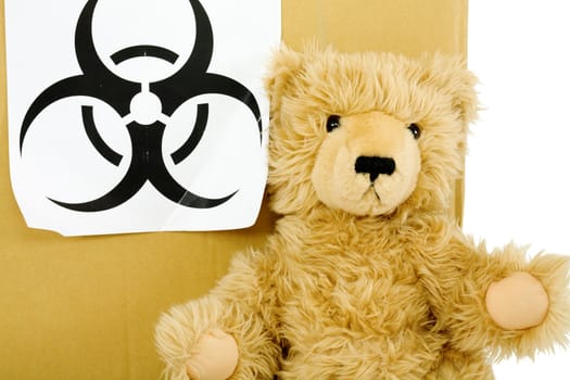 Toy bear and sign biohazard on the white background