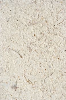Detail of the rough surface of the handmade paper with remains of plants - natural product
