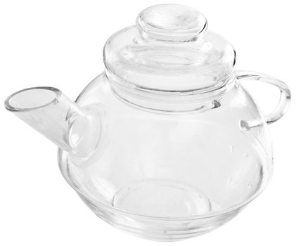 The transparent glass scalded tea-pot with a lid standing on a table