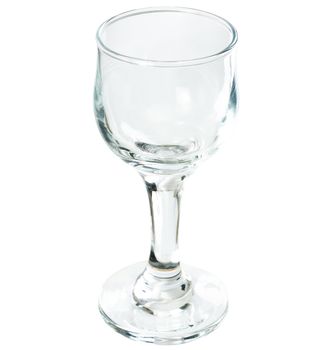 A transparent glass on a long thin leg on a white