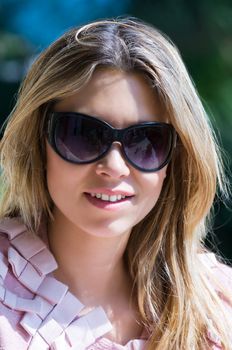 Image shows a pretty girl with sunglasses