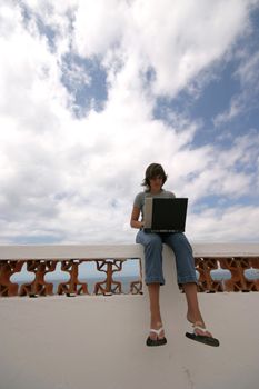 man working with laptop on the coast