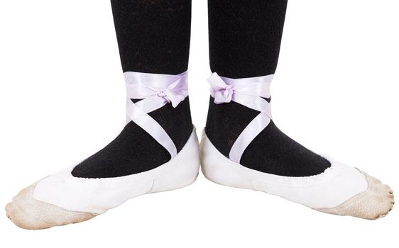 On the tips of the toes on the white background