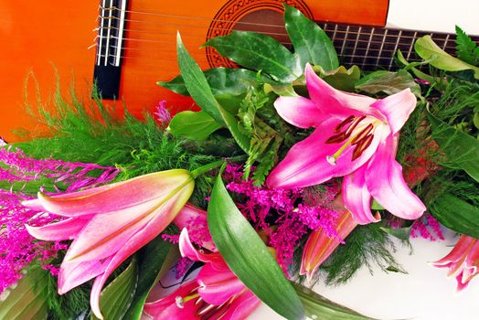 pink lily and guitar composition over white