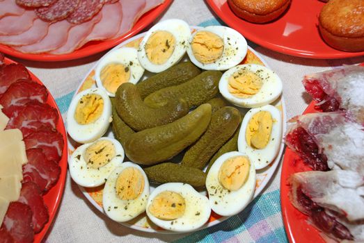 green cucumbers with boiled eggs served on plate
