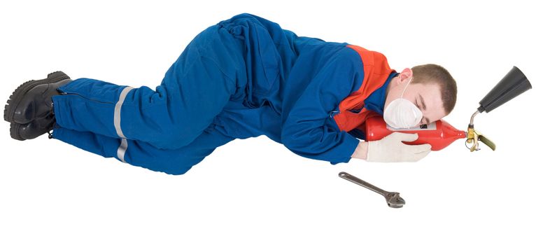 Tired worker sleeps on fire-extinguisher on the white background