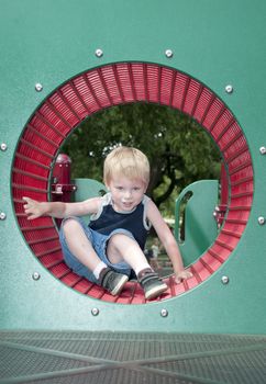 young child having fun and playing in the park on a sunny day