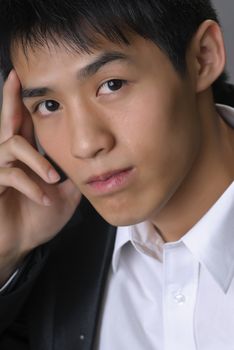 Handsome young business man of Asian, closeup portrait with face.