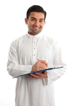 A smiling ethnic businessman writing on a clipboard folder