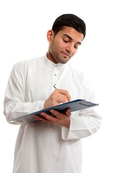 An ethnic businessman in traditional clothing, holding a clipboard folder and writing with a pen.  White background.