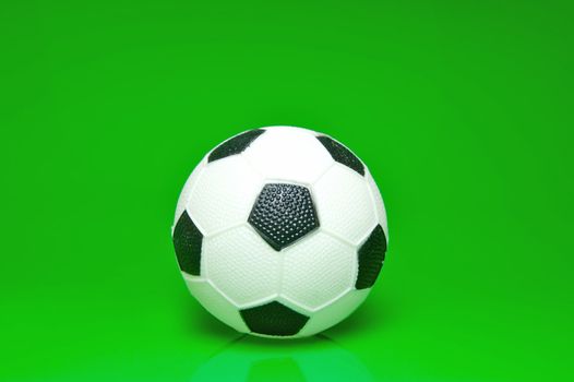 A soccer ball isolated against a green background