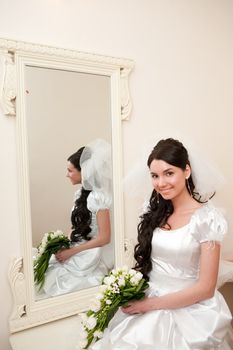 a girl by a mirror