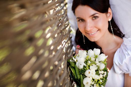 young bride near the hedge