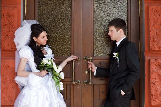 bride and groom near the door