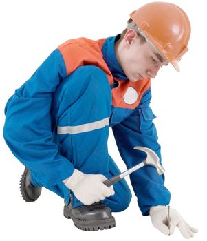 Builder with nail and hammer on the white background