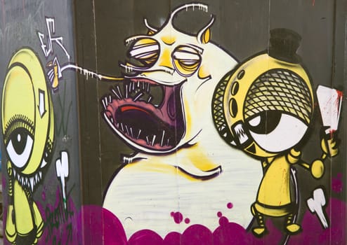 Graffiti on a wall depicting aliens and monsters