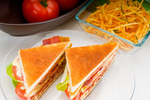 fresh and delicious classic club sandwich over a transparent glass dish