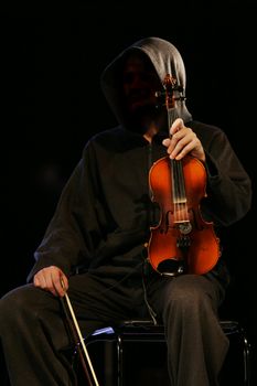 The musician with a violin on a dark background