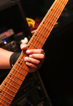 Details of a rockgig. Man's hand and guitar