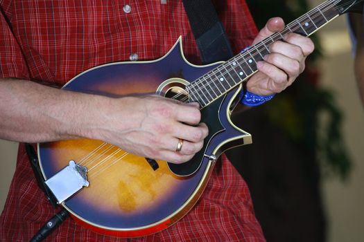 Part of a mandoline and hand man close-up