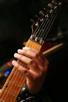 Details of a rockgig. Man's hand and guitar