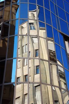 urban building in mirror reflection in other building