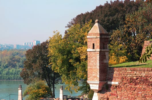 brick tower over autumn trees in park Kalemegdan in Belgrade