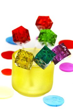 bounch of colorfull translucent dice shaped lollipops backlit on white background