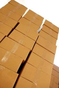 piles of paper boxes with goods in storage
