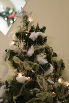 A green christmas tree with many decorations