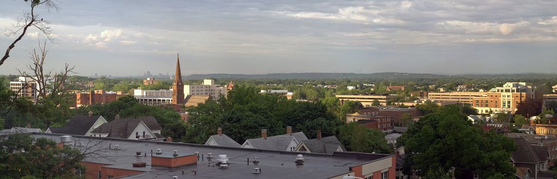 A wide angle panoramic view of downtown New Britain Connecticut with the Hartford skyline also visible far off in the distance.