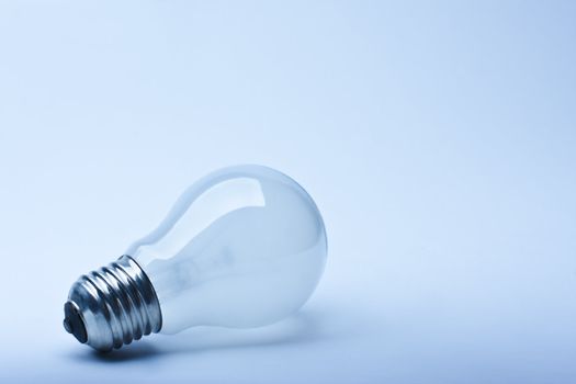 Close-up isolated light bulb in blue lighting