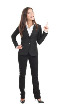 Businesswoman pointing / showing in full length isolated on white background. Young confident mixed race chinese / caucasian woman business woman.