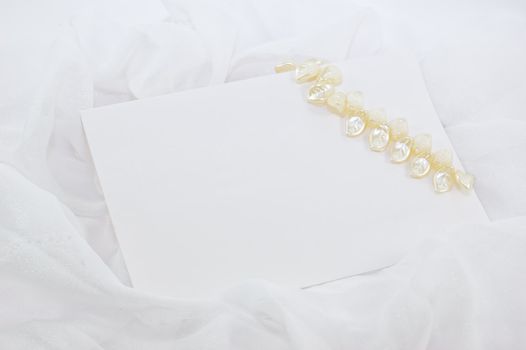 blank note with decoration over white fabric