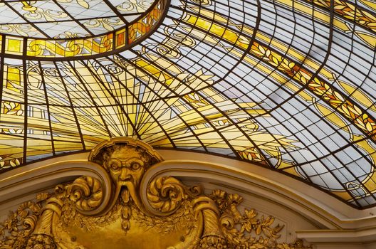 Gold colored stained glass windows as part of a domed cieling