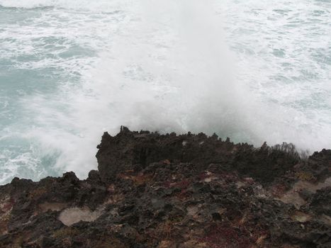 wave crashing on a cliff