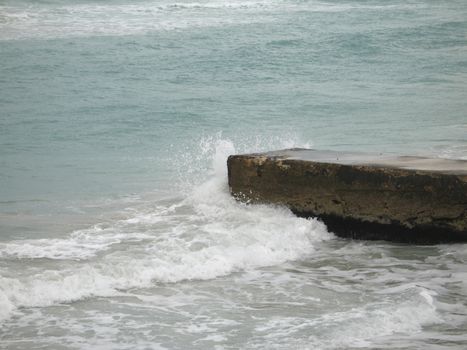 wave crashing on a dock