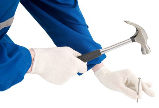 Male hand with hammer and nail on a white background