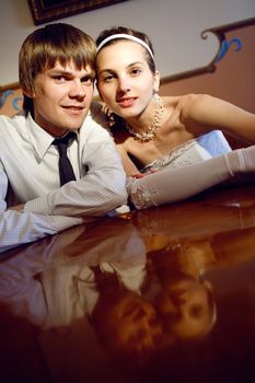 happy bride and groom at the table